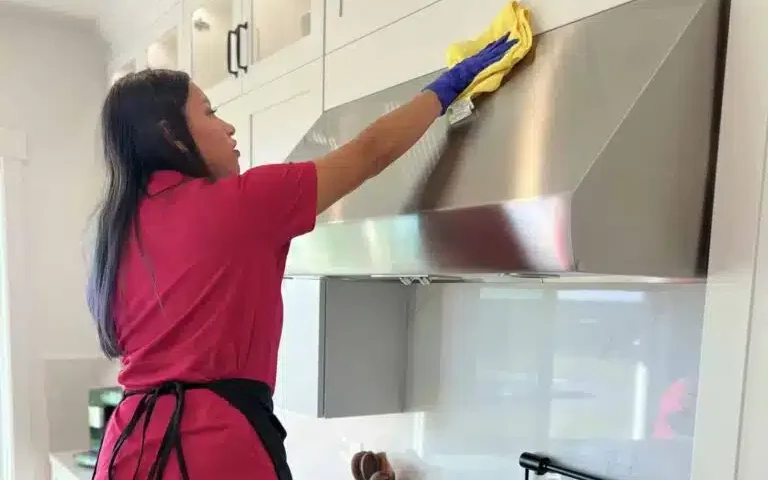 A cleaner performing a detailed deep-cleaning task.